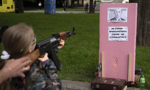 Victoria, de siete años, dispara balas de plástico a un retrato del presidente ruso Vladimir Putin, en una atracción callejera en el centro de Leópolis, Ucrania.Foto Ap